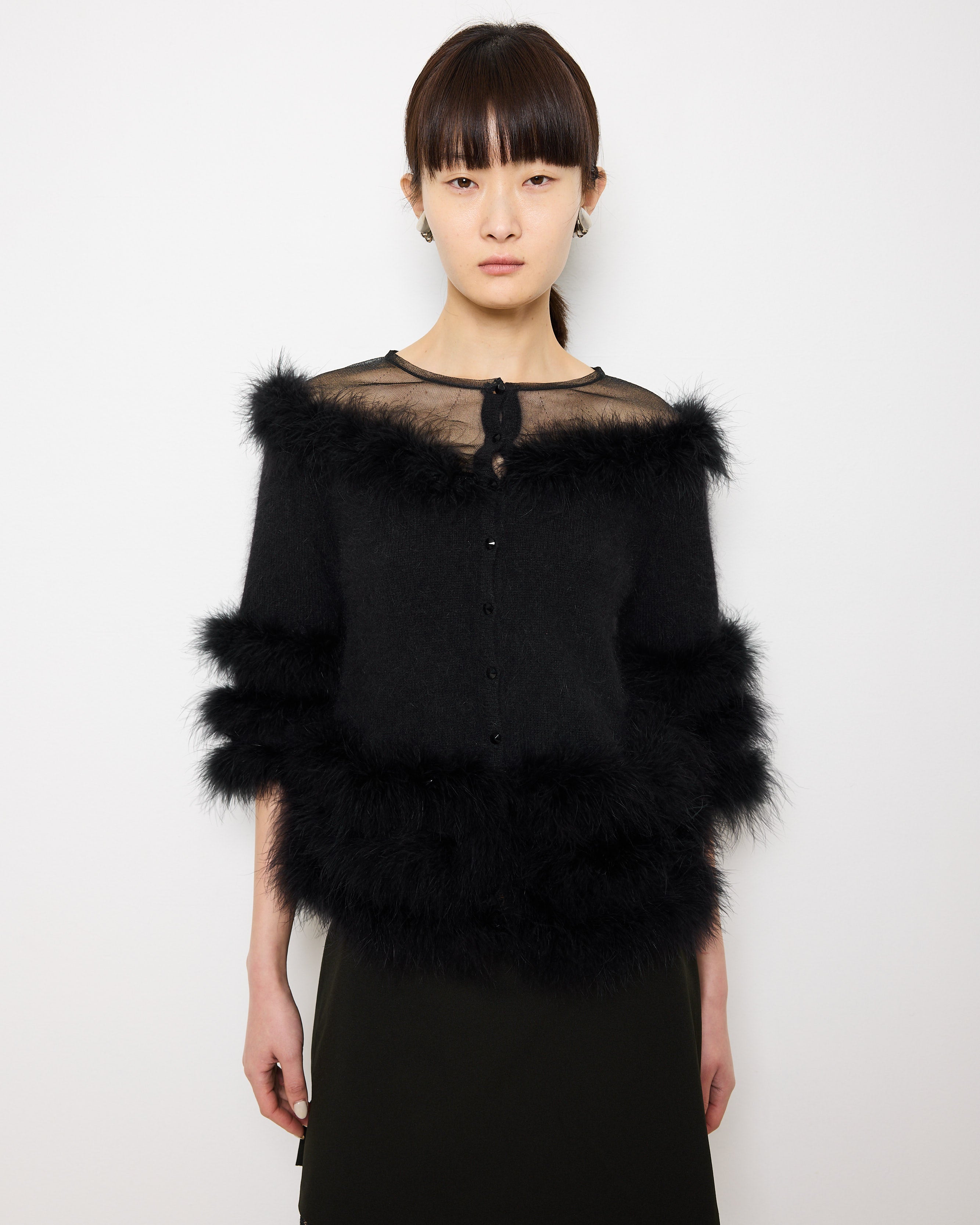 Discover the Purificación García Fur Coat – a 22-inch, size S vintage coat, crafted from angora blend with 100% duck feather details. In very good condition, modeled by someone 5'9" tall.