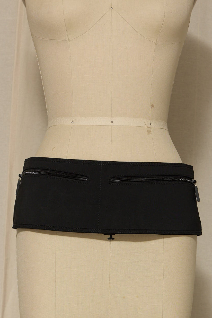 Black skirt on a mannequin against a plain background