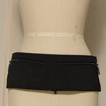 Black skirt on a mannequin against a plain background