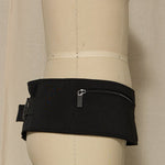 Black waist bag on a mannequin against a neutral background