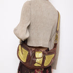 Brown leather shoulder bag with gold mesh details, 7x19 inches, 17-inch strap, multi-pocket design