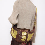 Brown leather shoulder bag with gold mesh details, 7x19 inches, 17-inch strap, multi-pocket design