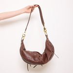 Brown leather shoulder bag with gold mesh details, 7x19 inches, 17-inch strap, multi-pocket design