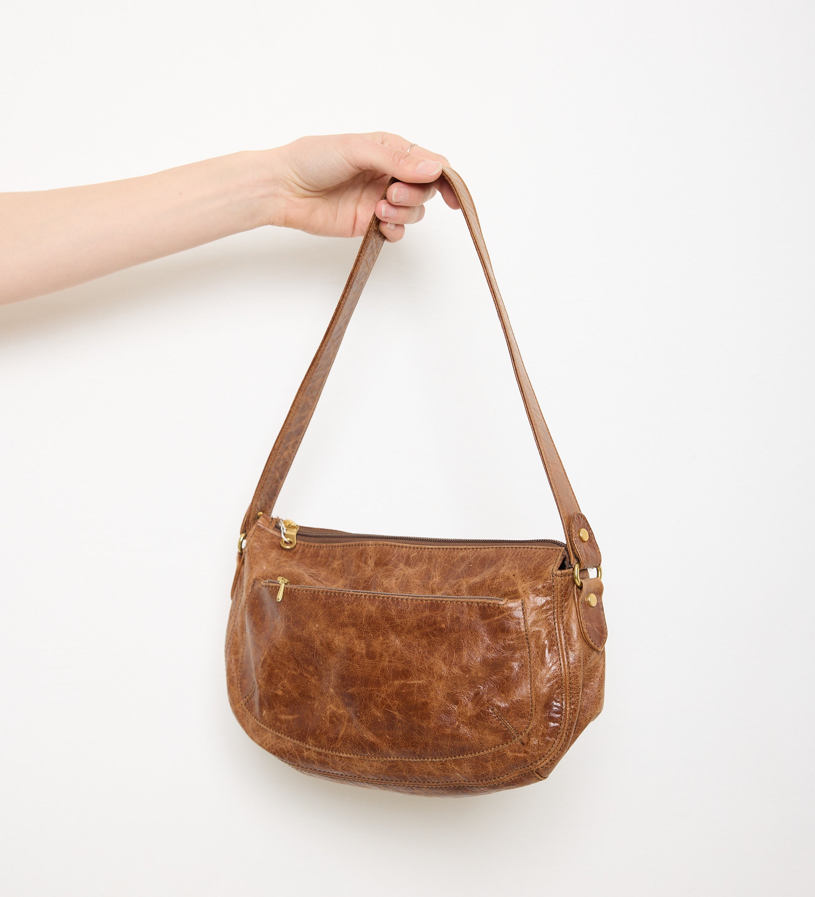 Vintage slouchy brown leather shoulder bag with gold-tone zipper and wide flat strap, shown front and back