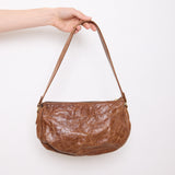 Vintage slouchy brown leather shoulder bag with gold-tone zipper and wide flat strap, shown front and back