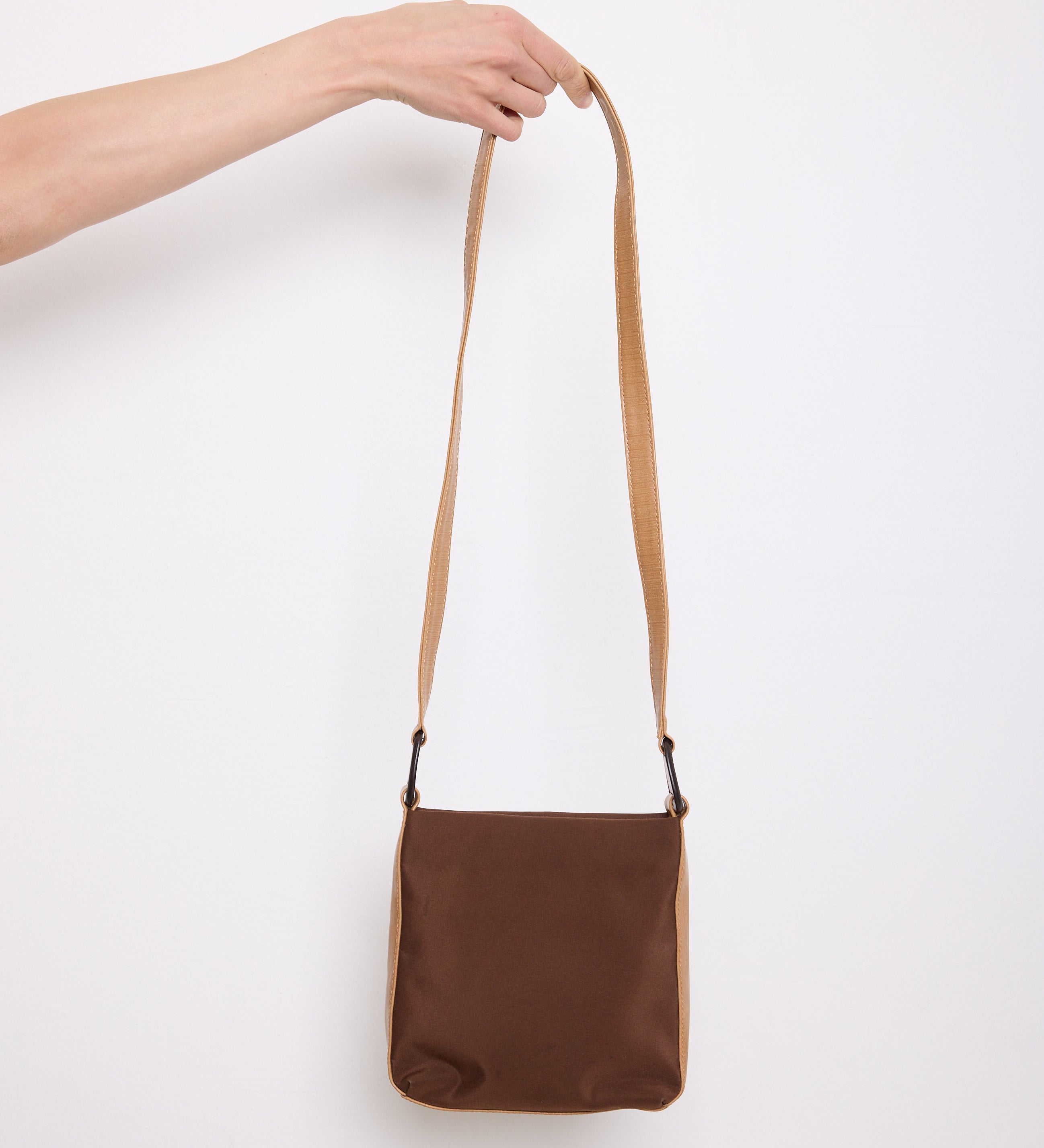 Brown nylon crossbody bag with tan strap, 7.5” long by 8” wide, 38” strap length.

