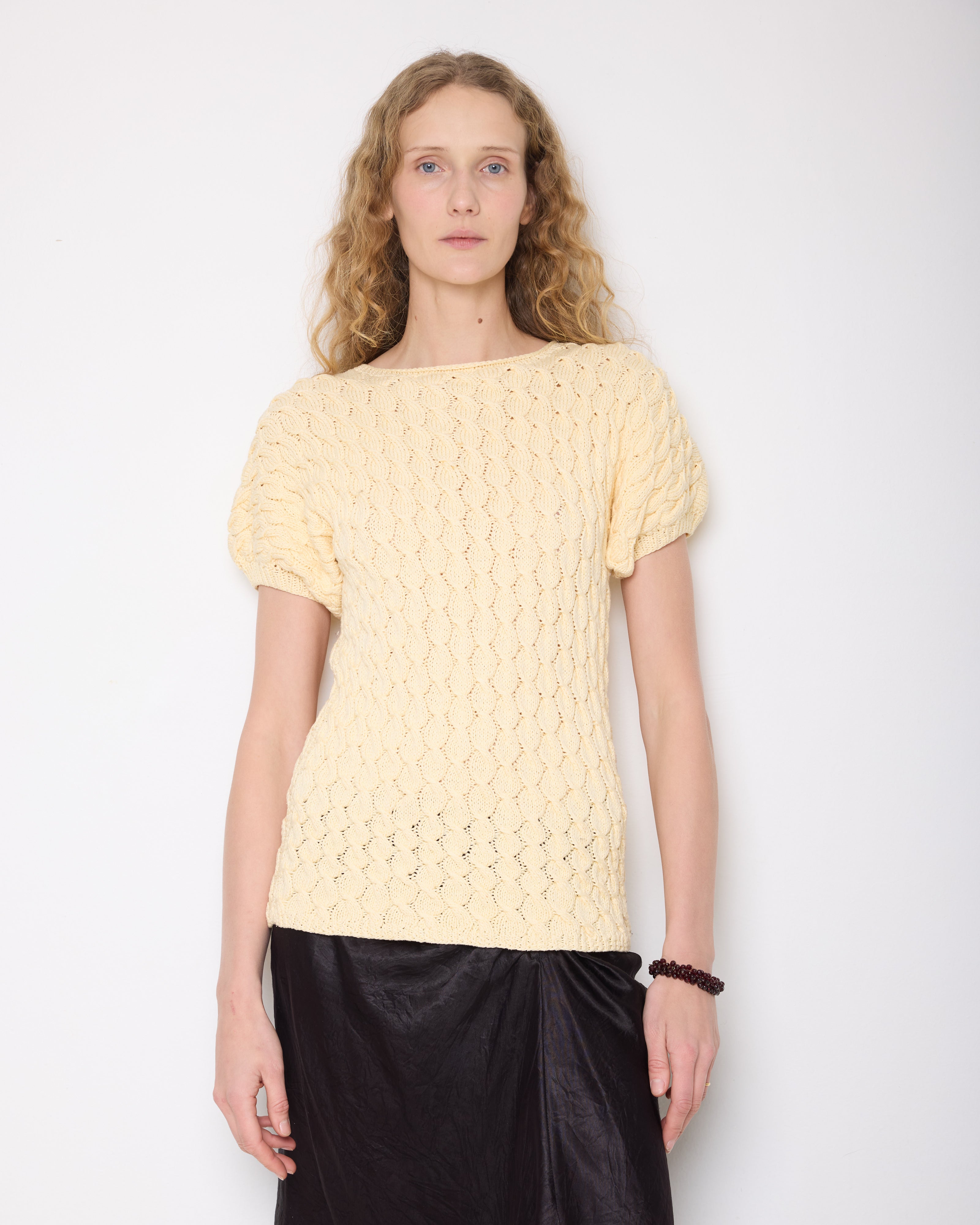 Discover the Buttercream Braided Knit Top – a handmade vintage piece in very good condition. With a 26-inch length and designed for sizes M-L, its elegant braided design and buttery color offer versatile, stylish comfort