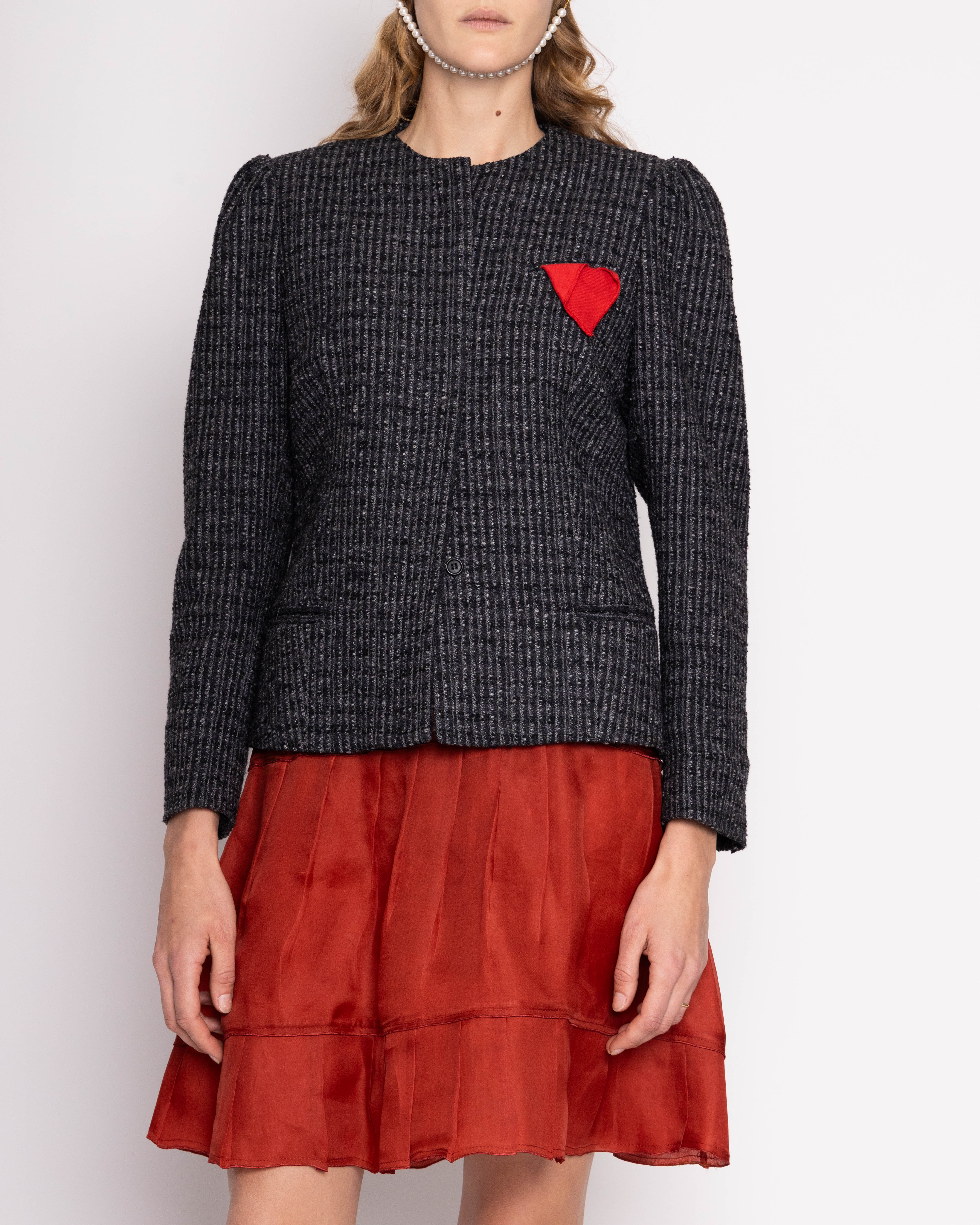 Discover the Ann Klein Ornamental Lapel Blazer – a vintage piece in mint condition crafted from pebbled grey tweed. Features a unique handkerchief detail, 25" length, 16" shoulder width, with model at 5'11". Embrace timeless elegance with this statement blazer